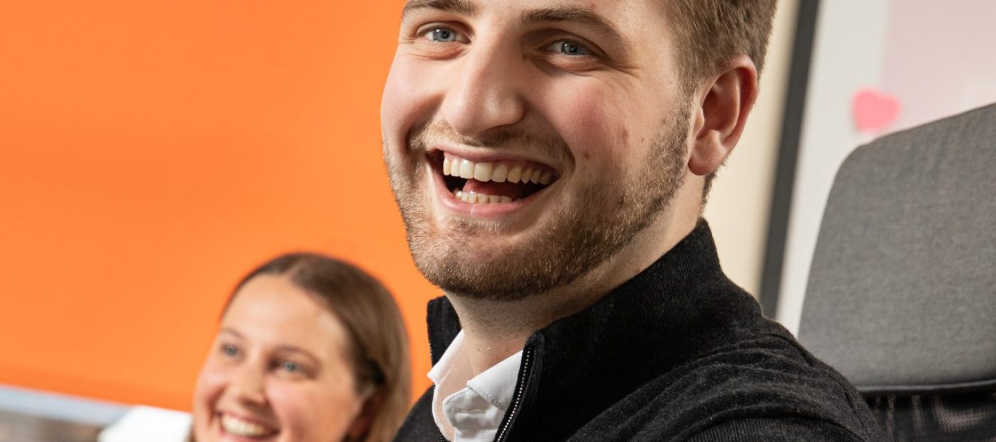 Chadsan guildford office team laughing at their desk