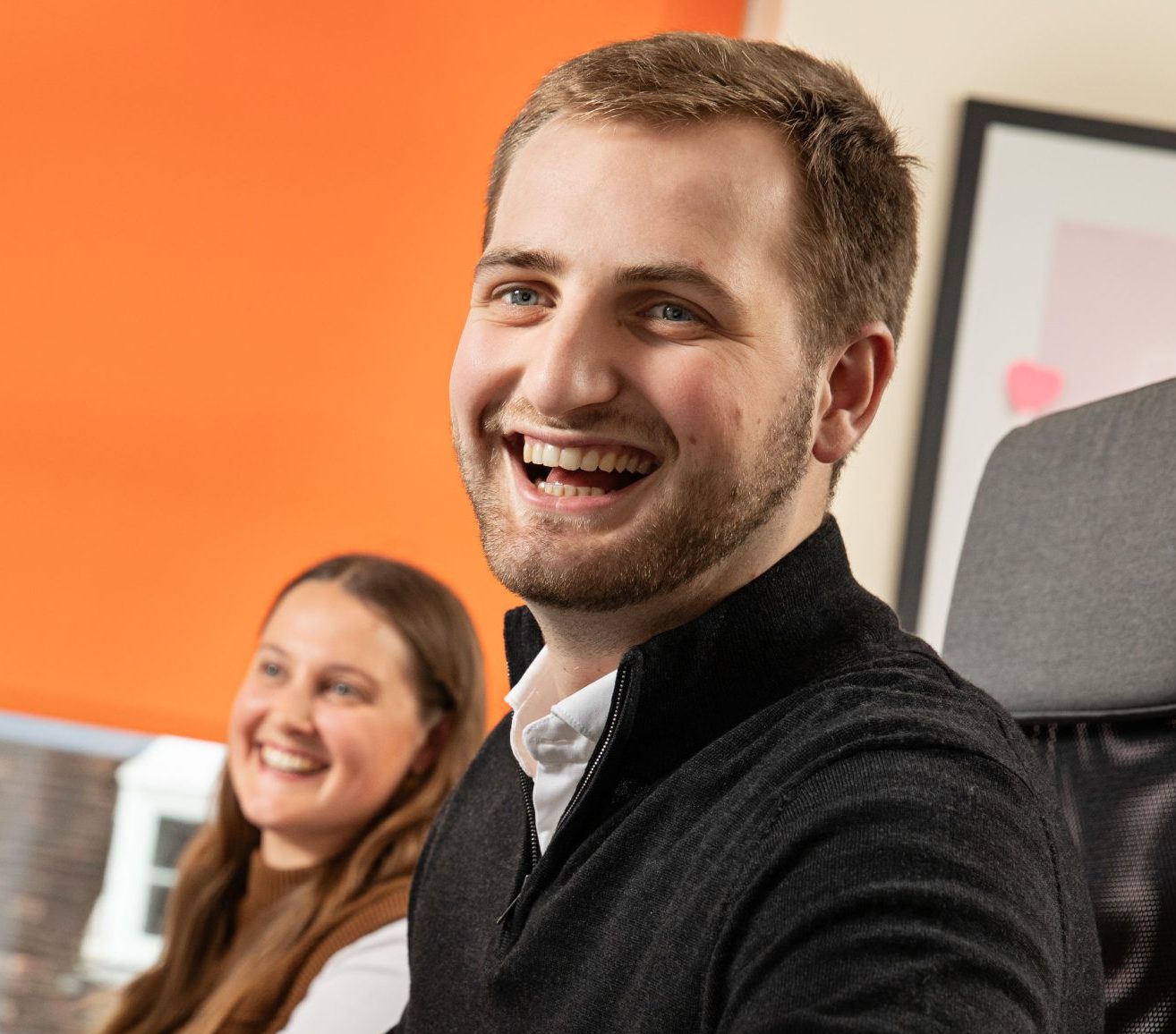Chadsan guildford office team laughing at their desk