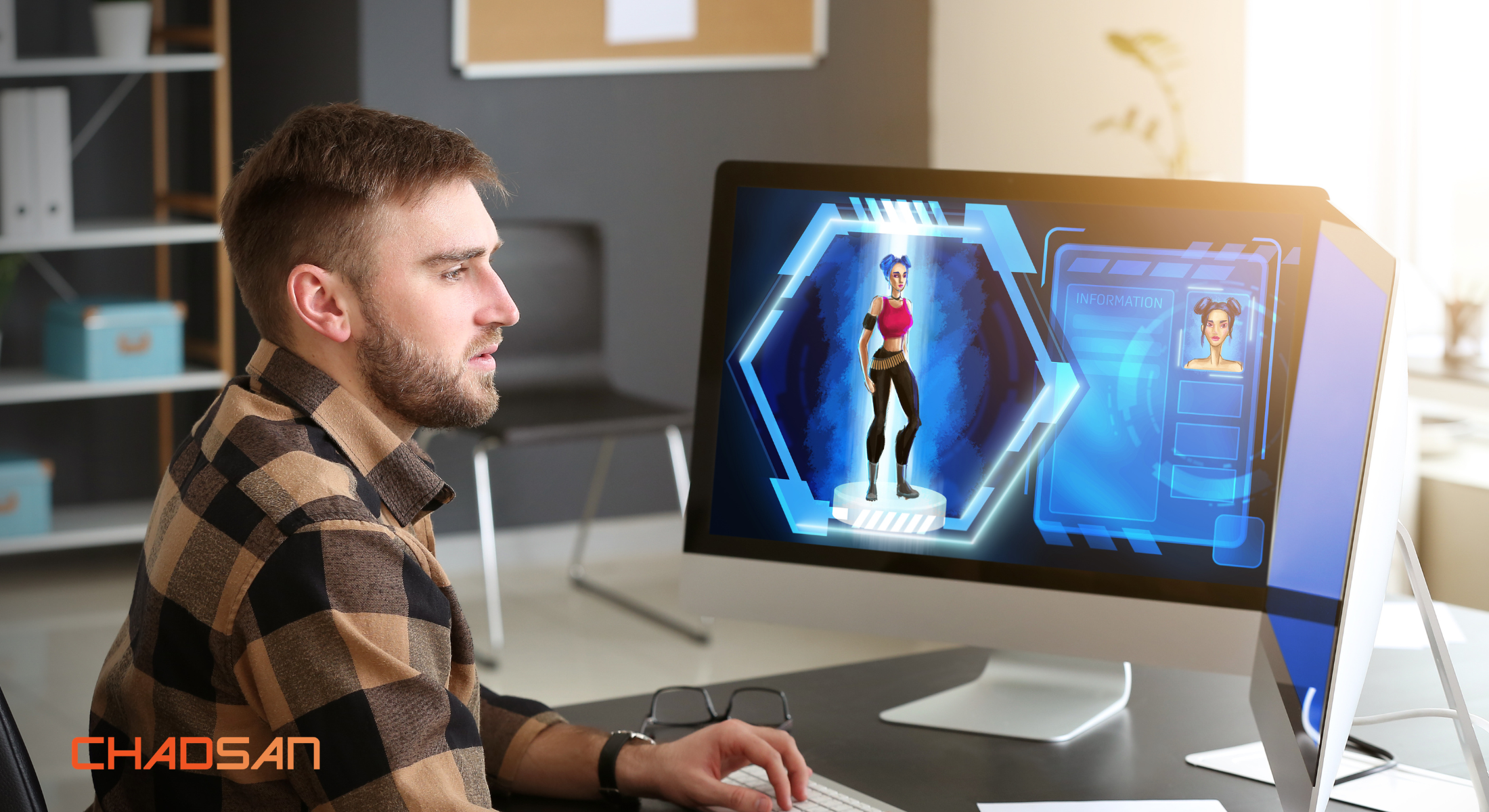 Man developing a game on his computer in the office with chadsan logo